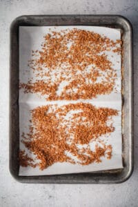 Toasted coconut shreds on a baking sheet.