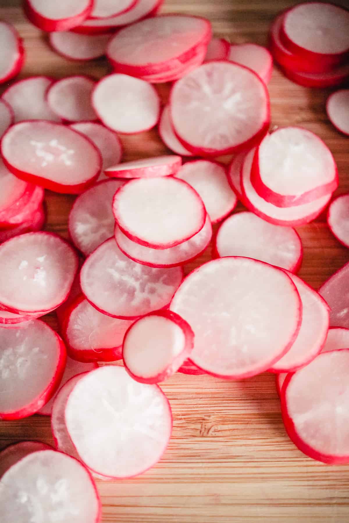 Sliced radishes on a cutting board.