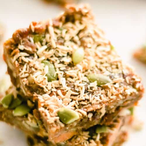 Closeup of Homemade Sweet Potato Energy Bars topped with pumpkin seeds and coconut.