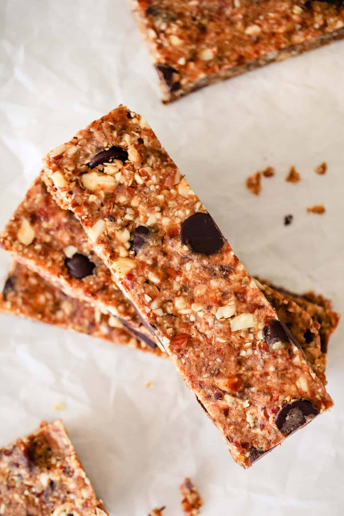 Stack of homemade energy bars on parchment paper.