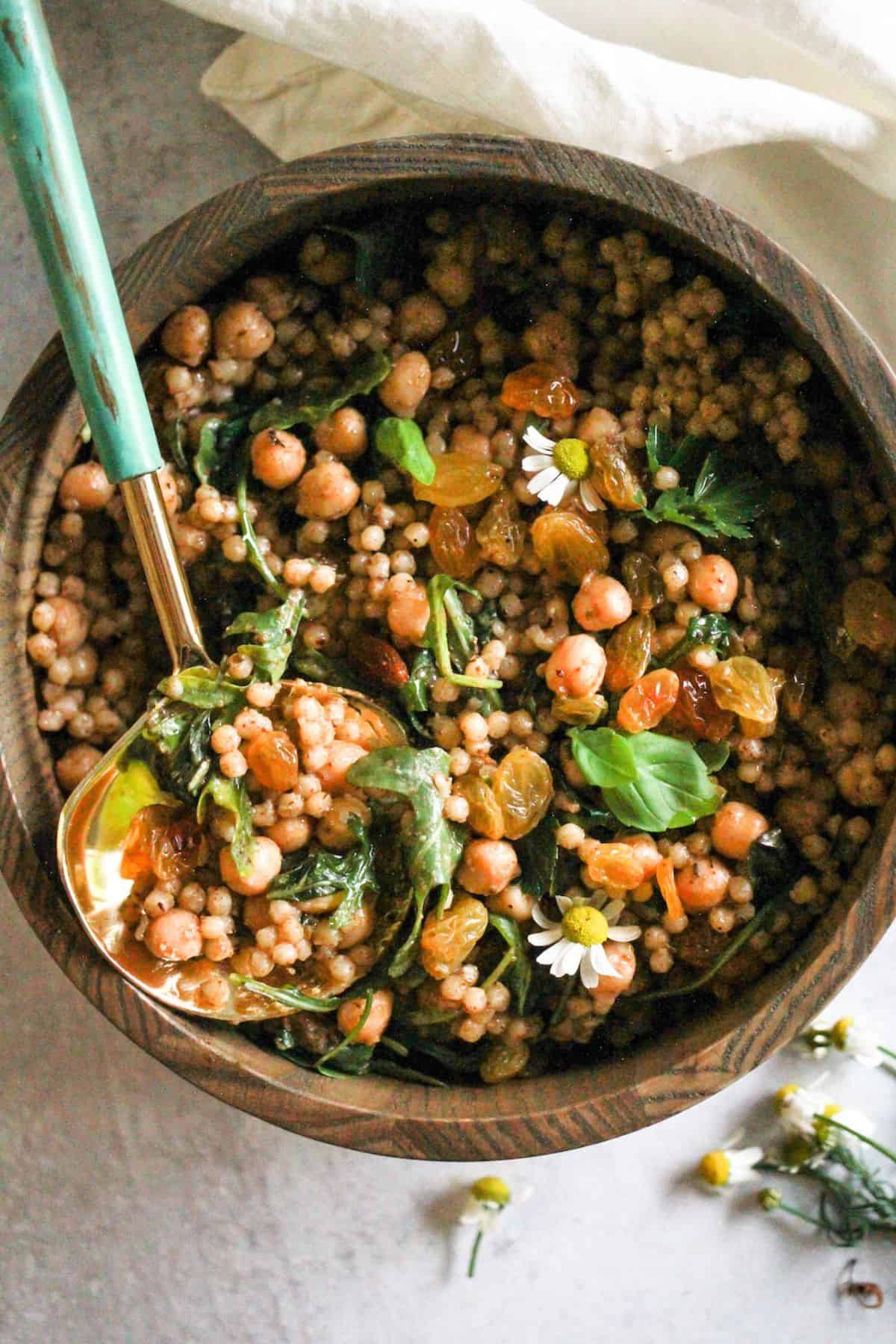 Easy vegetarian coucous salad with chickpeas in a wood bowl.