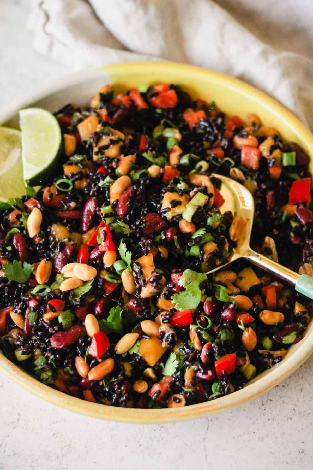 Vegan black rice salad with beans, peanuts, and mango