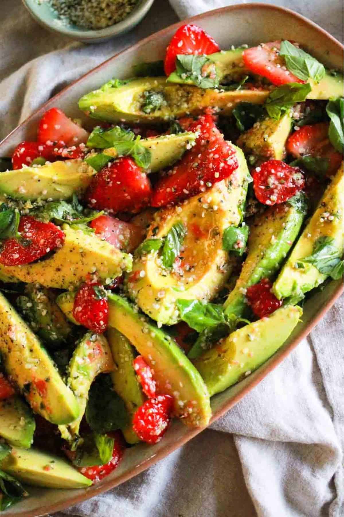 Easy vegetarian salad with strawberries, avocado, and lemon hemp dressing.