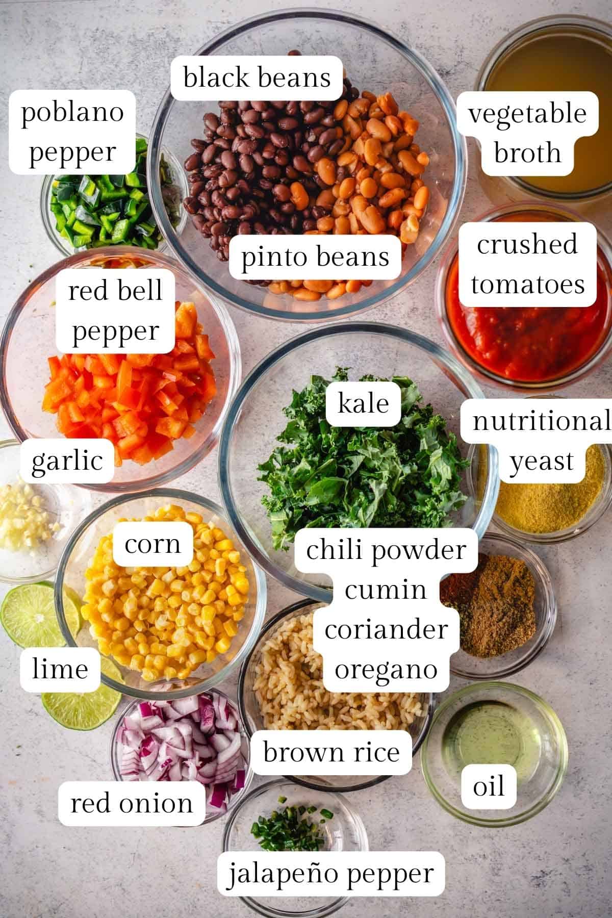 Labeled ingredients in glass bowls to make a taco soup with rice and beans.