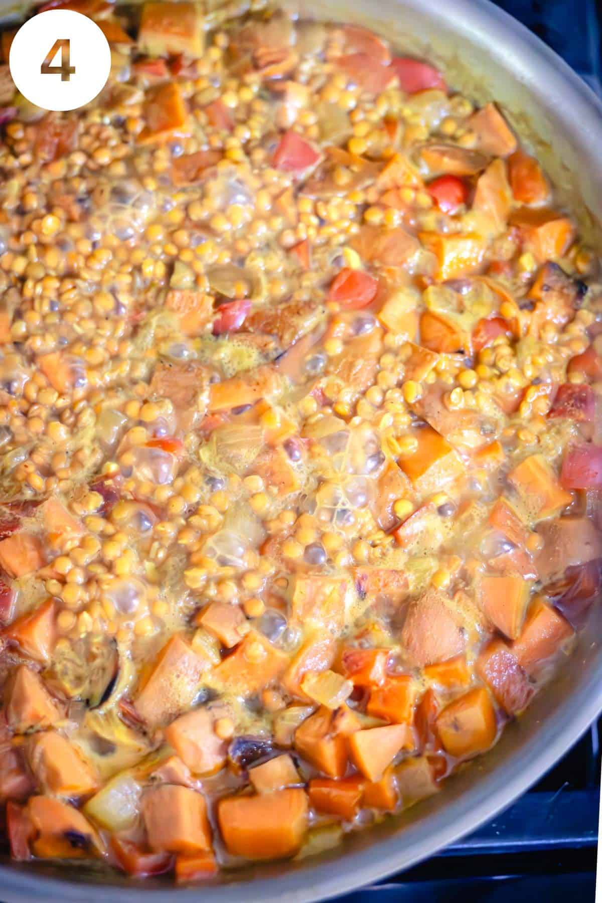 Lentils cooking in water in a skillet with vegetables and spices. The photo is labeled with a number "4."