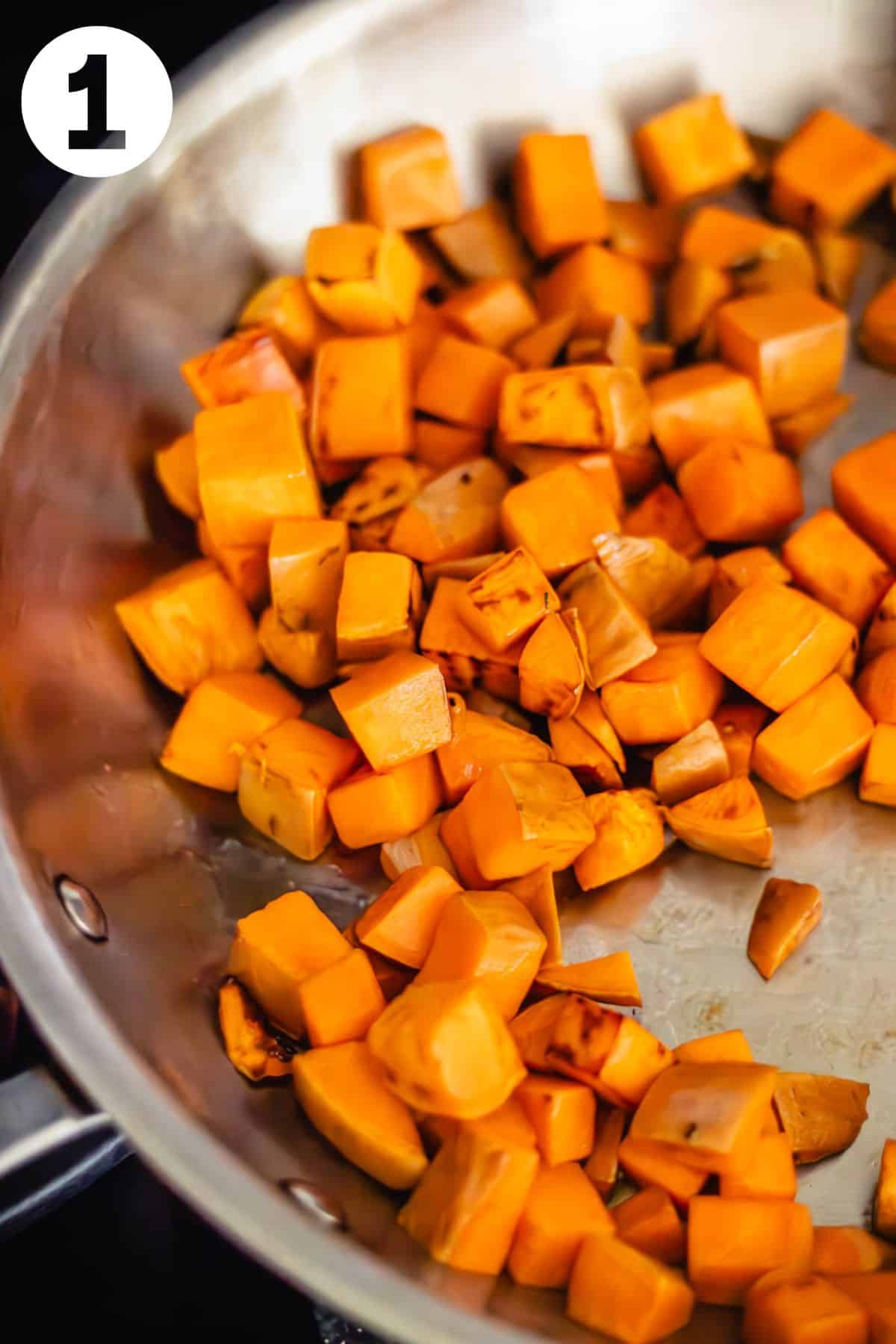 Browned sweet potato cubes in a skillet. The photo is labeled with a number "1."
