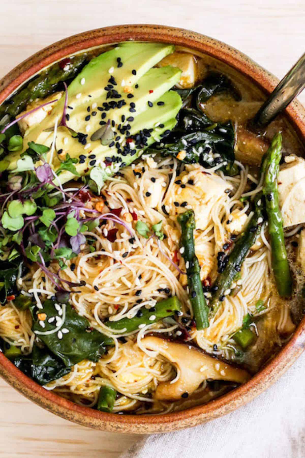 Vegan Ramen Noodle Soup with mushrooms, asparagus, and avocado.