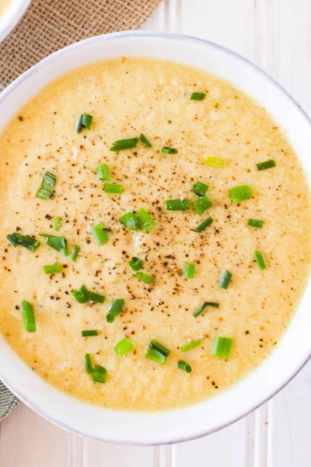 Creamy vegan potato leek soup topped with chives and black pepper.