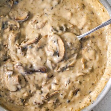 Closeup of thick and creamy vegan mushroom gravy in a skillet.