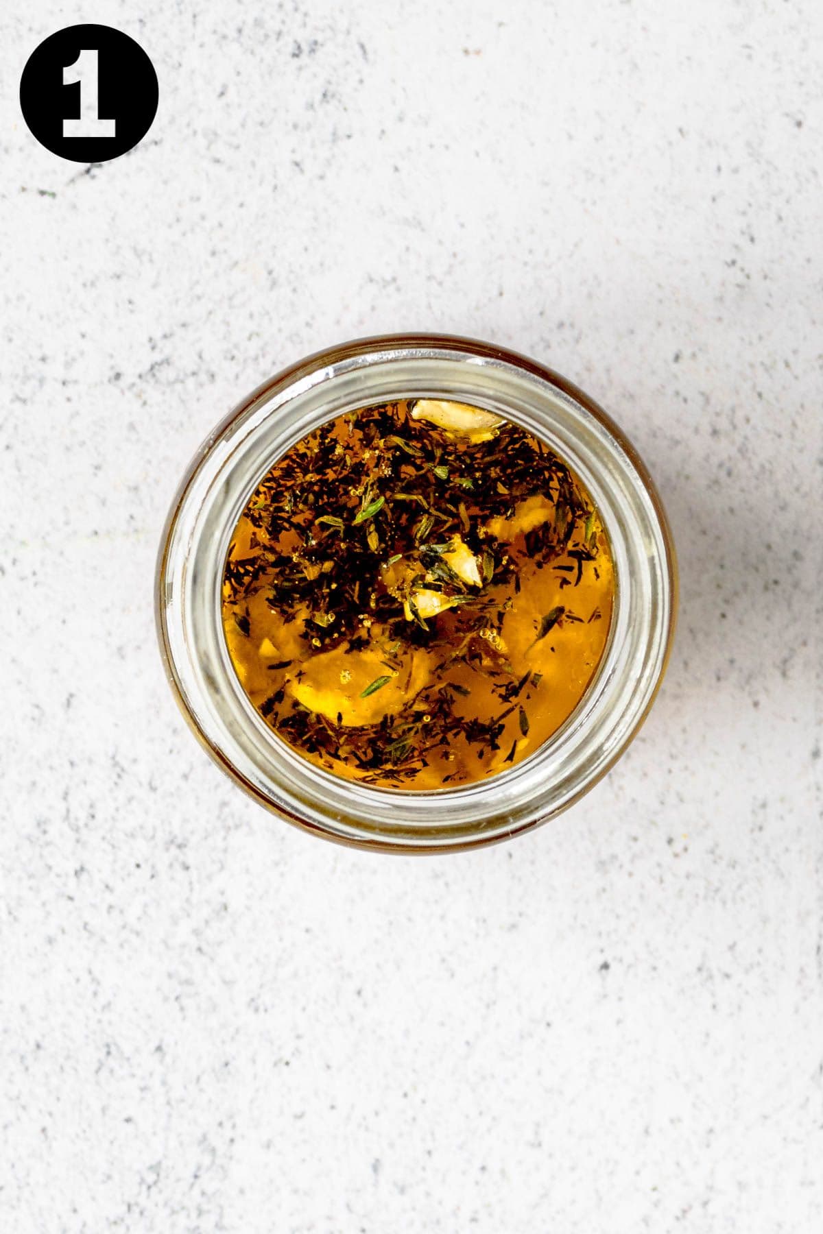 unmixed ingredients to make honey mustard dressing in a glass jar. There is a number "1" in the upper left corner.