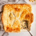 Creamy vegetarian vegetable pot pie in a square baking dish.