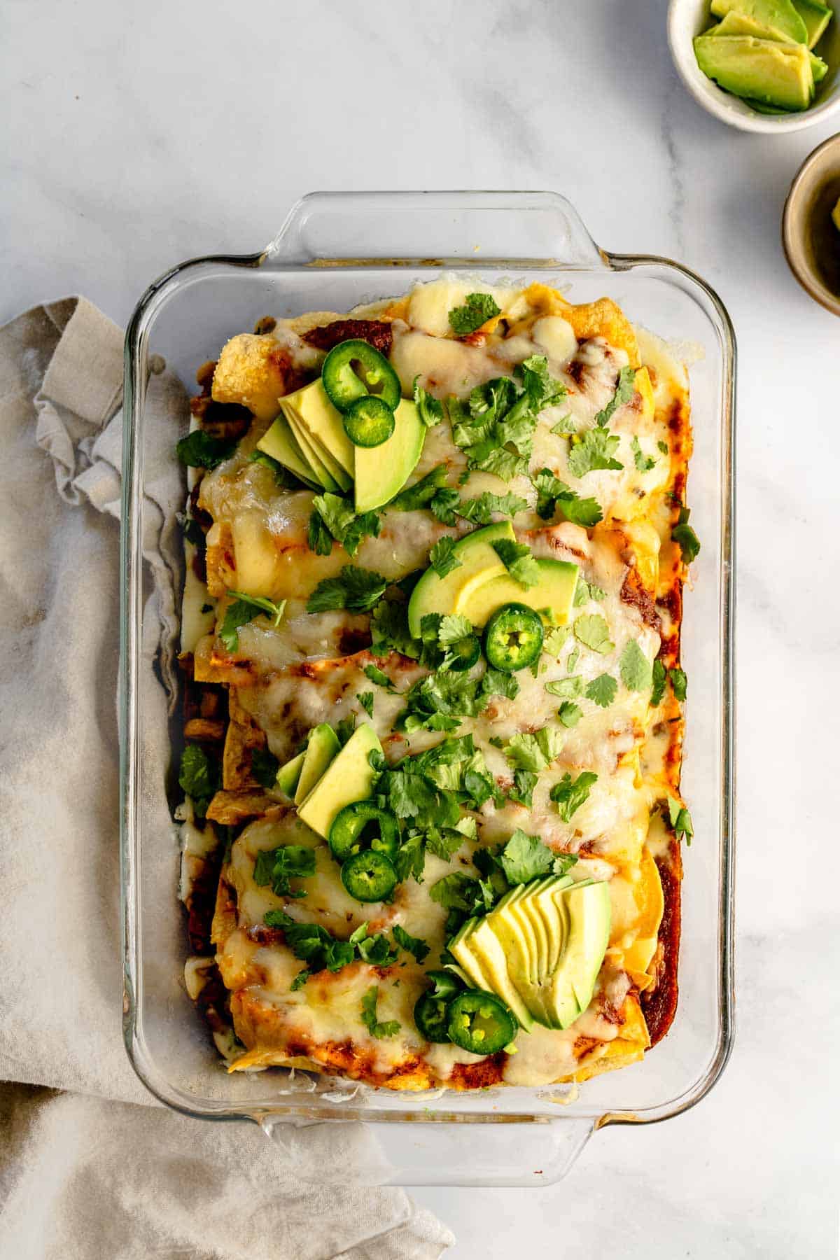 Enchiladas with homemade sauce in a glass baking dish