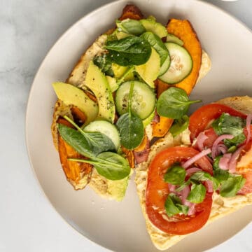 Open-faced hummus veggie sandwich with sweet potato.