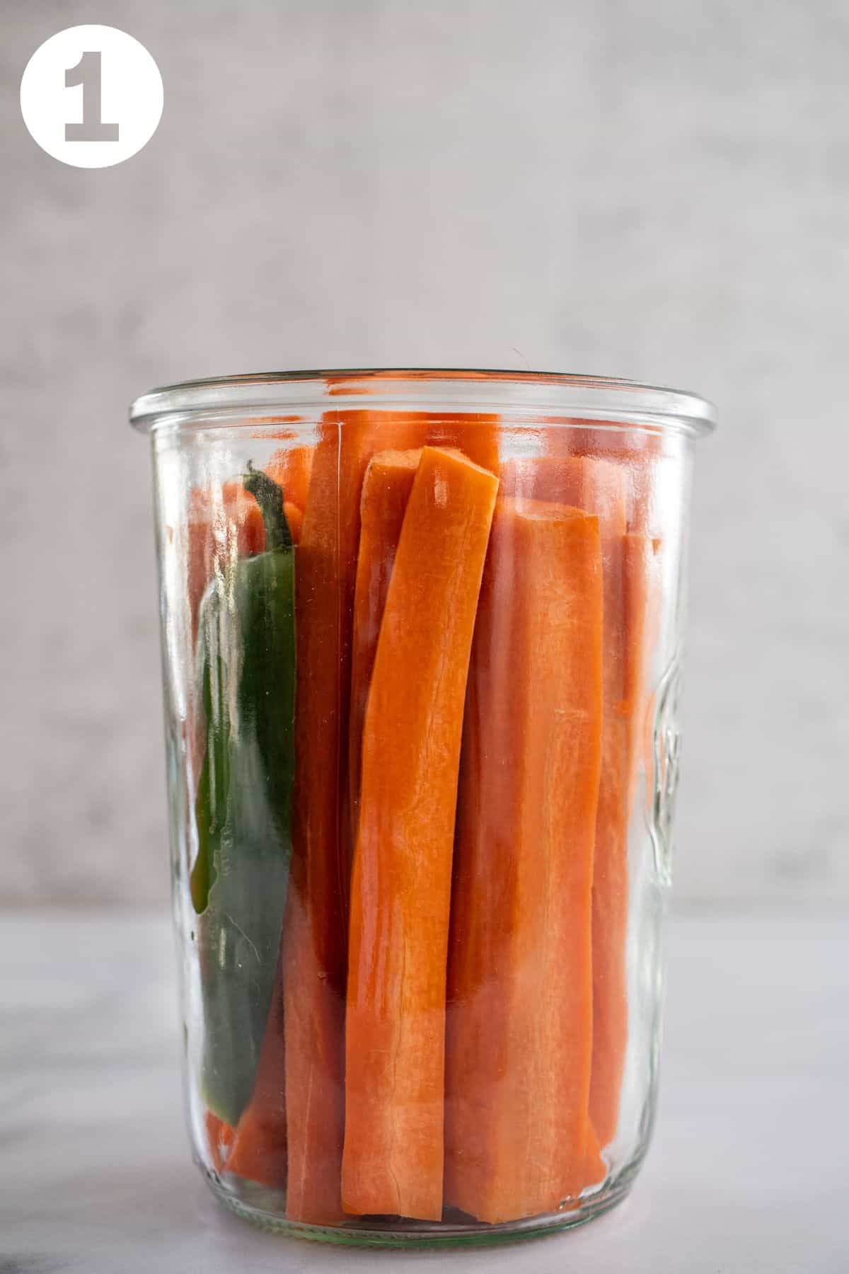 Carrot sticks in a glass jar. Labeled with a 