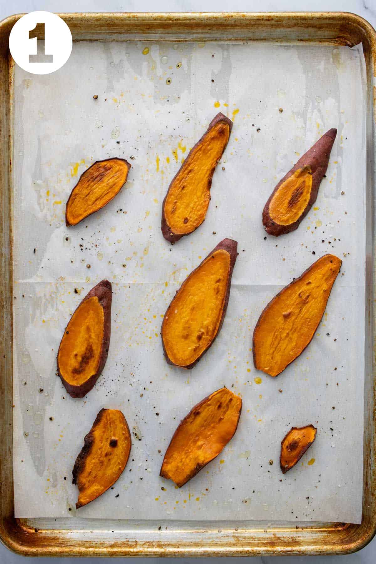 Thinly sliced roasted sweet potato on a baking sheet lined with parchment paper. Labeled 