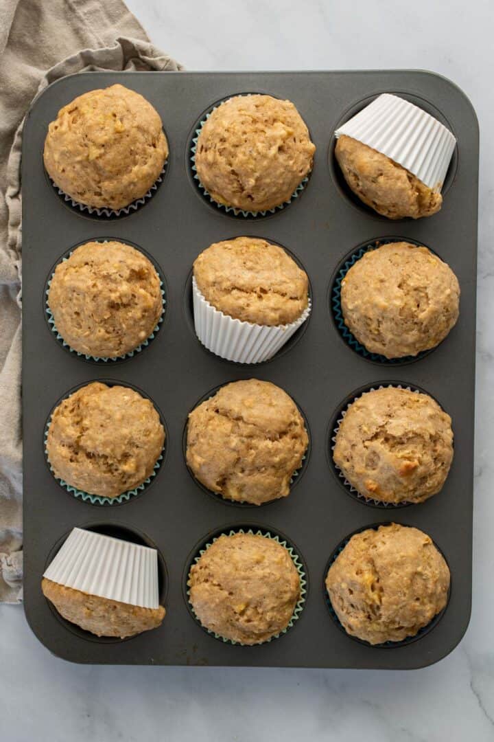 Banana oat muffins in a muffin pan.