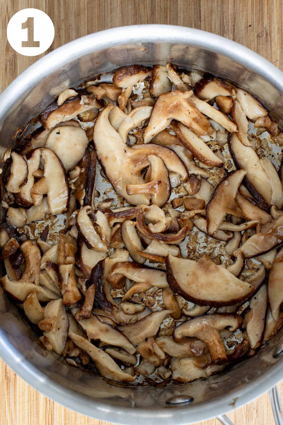 Sautéed shiitake mushrooms in a pot.
