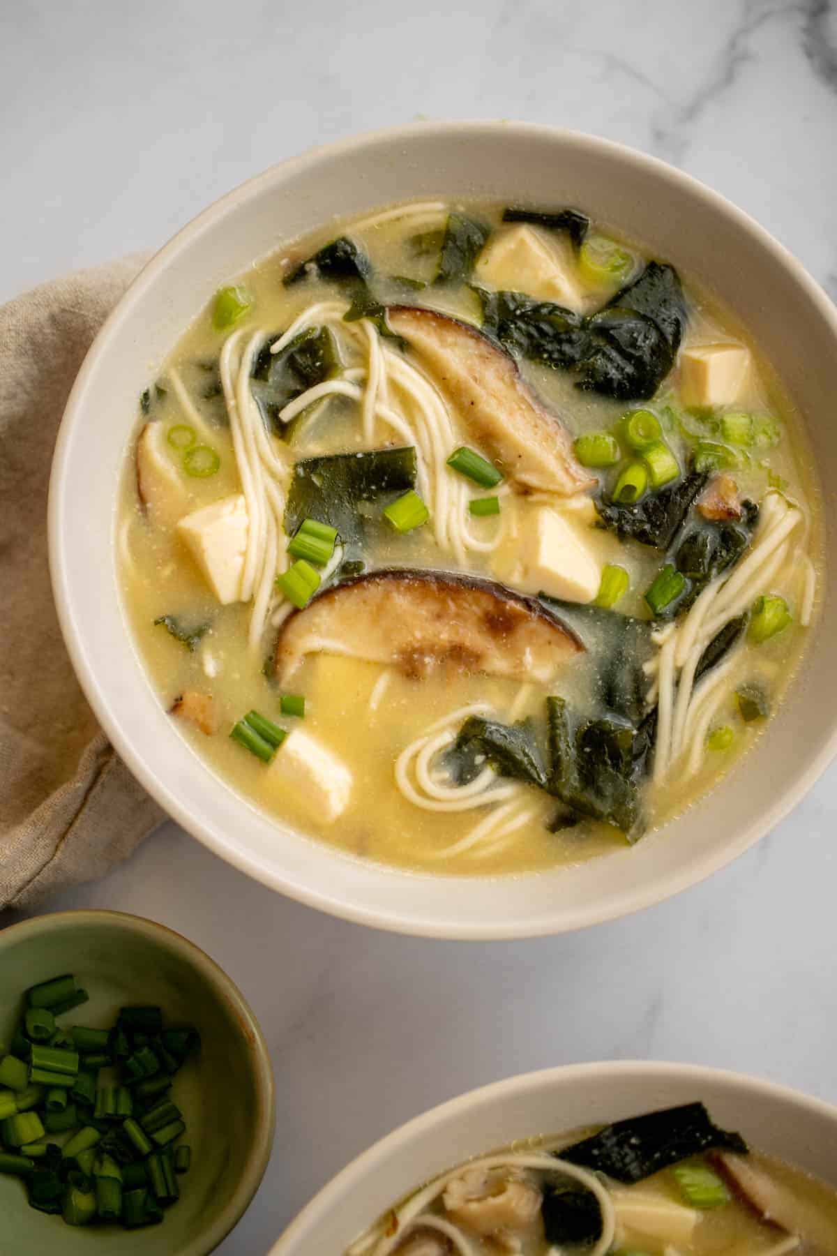 Bowl of vegetarian miso soup with shiitake mushrooms and tofu.