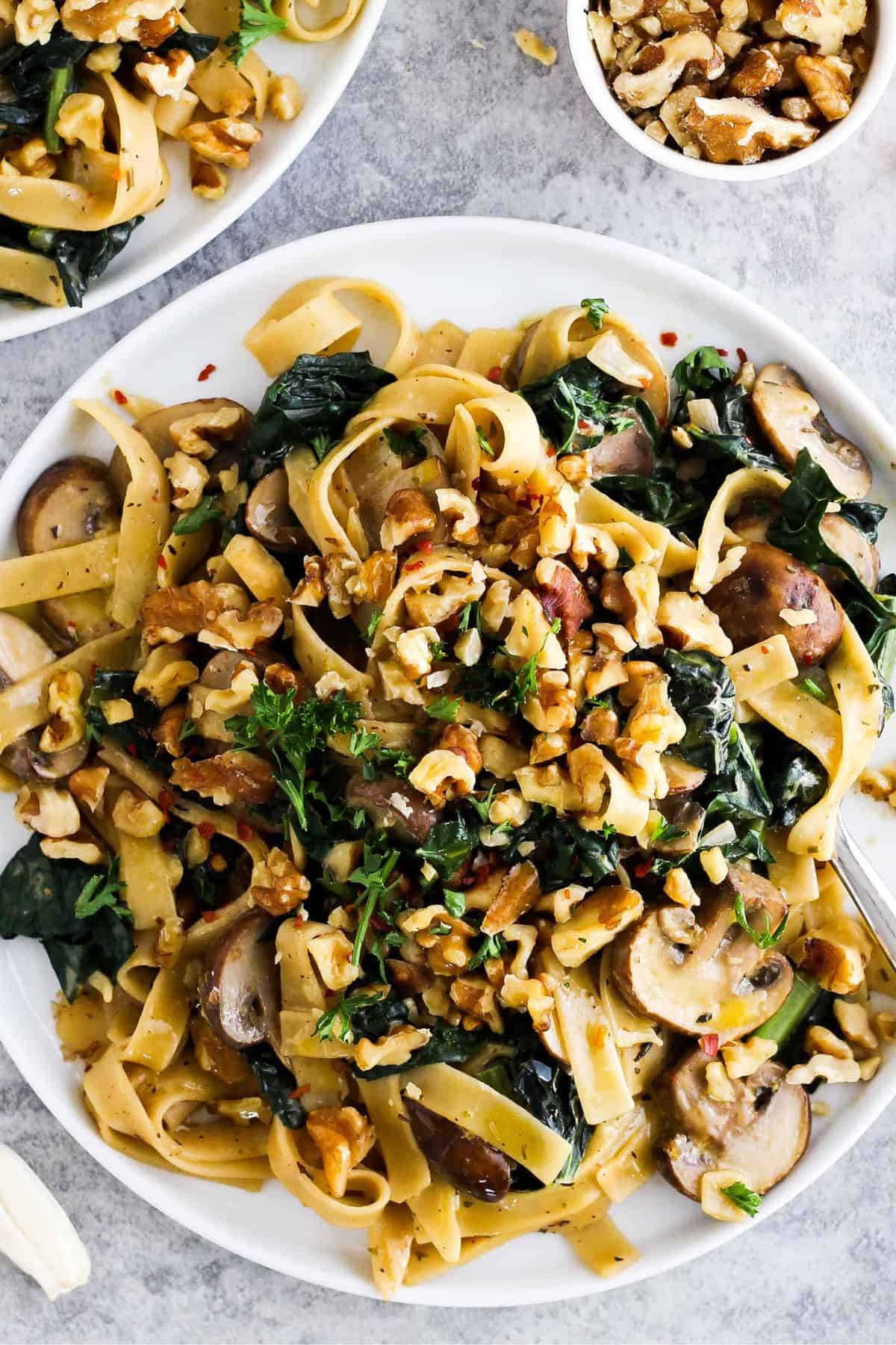 Creamy vegetarian pasta with mushrooms, kale, and nuts.