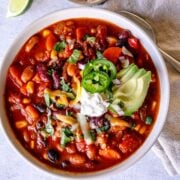 Vegetarian three-bean chili with corn and toppings.