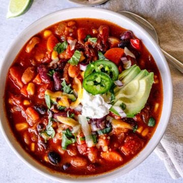 Vegetarian three-bean chili with corn and toppings.