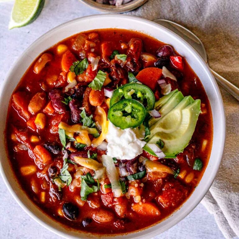 Vegetarian chili in a bowl with toppings.