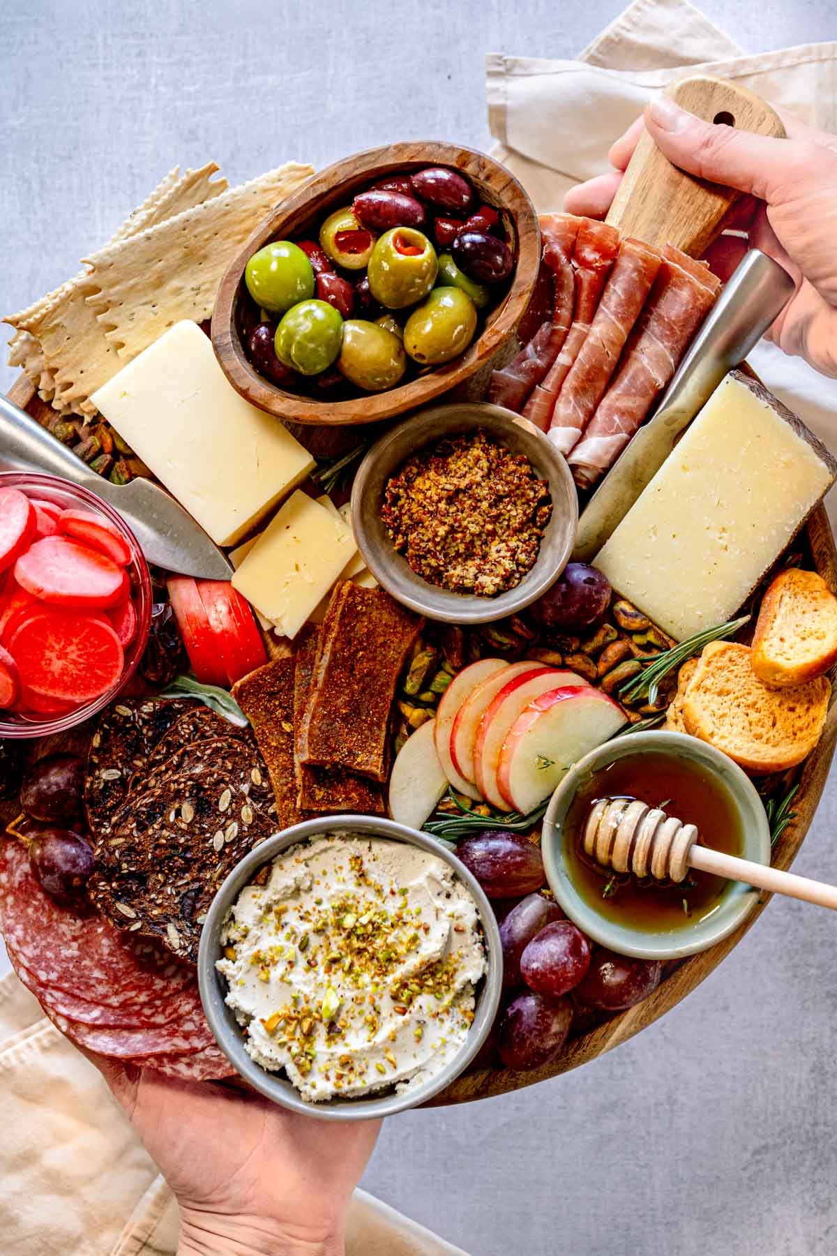 Holding a charcuterie board.