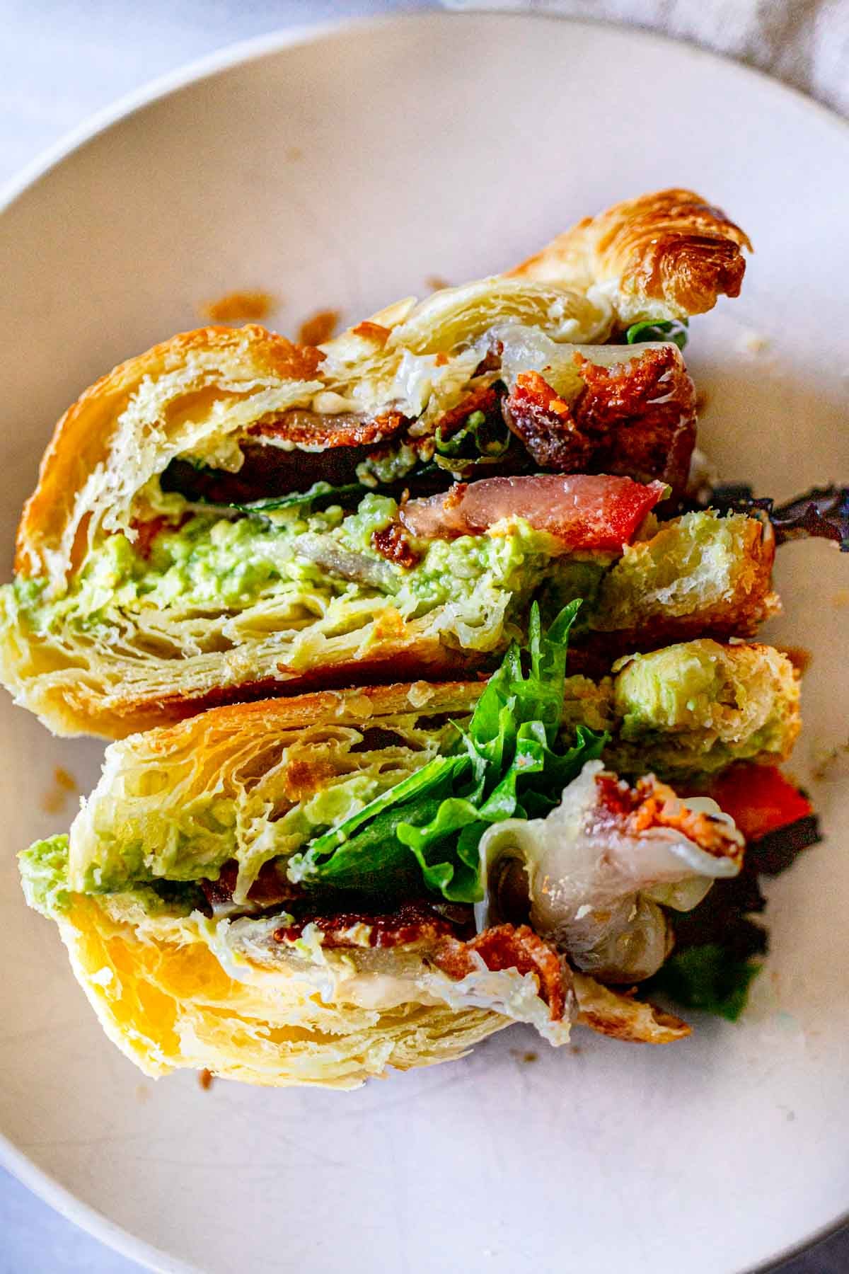 Bacon Avocado Croissant Sandwich, cut in half