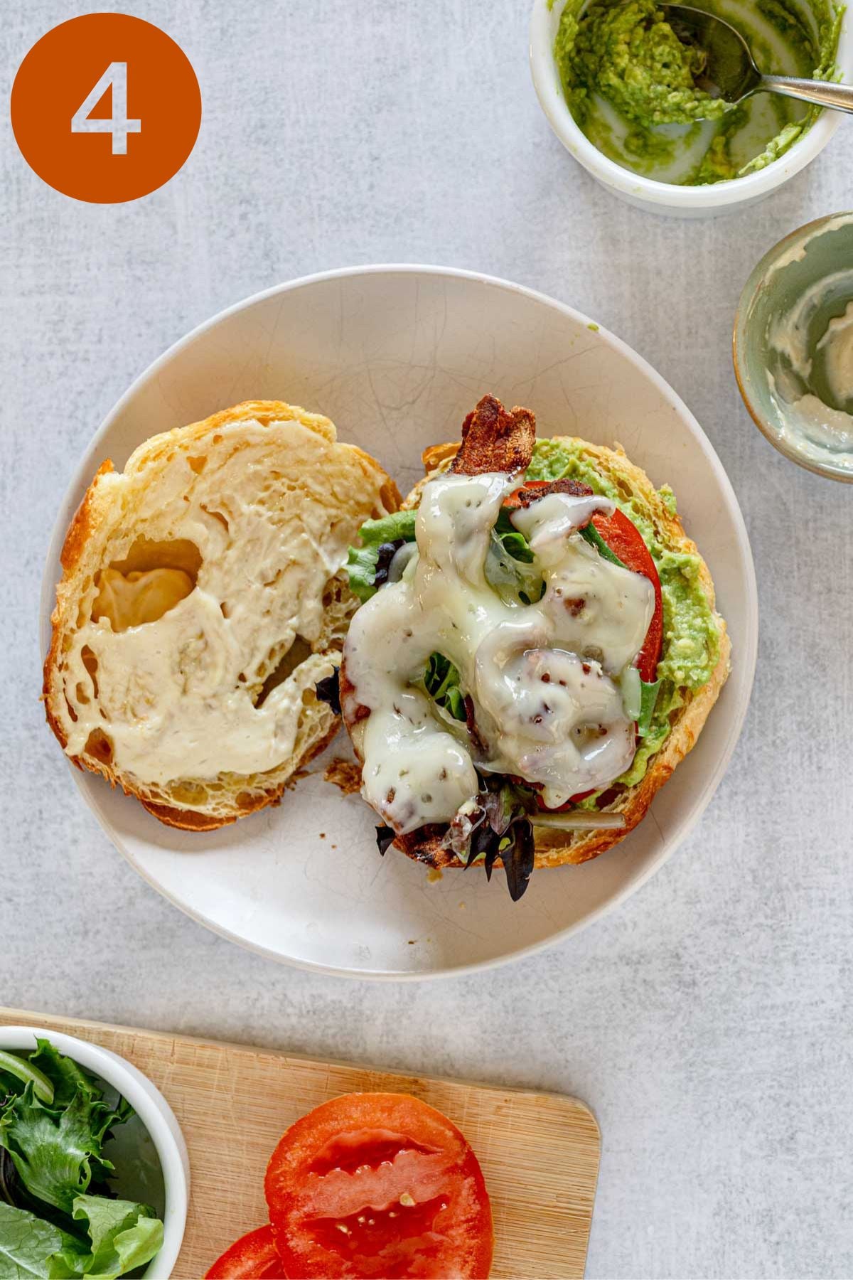Open-faced bacon Swiss avocado croissant sandwich. Labeled 4.