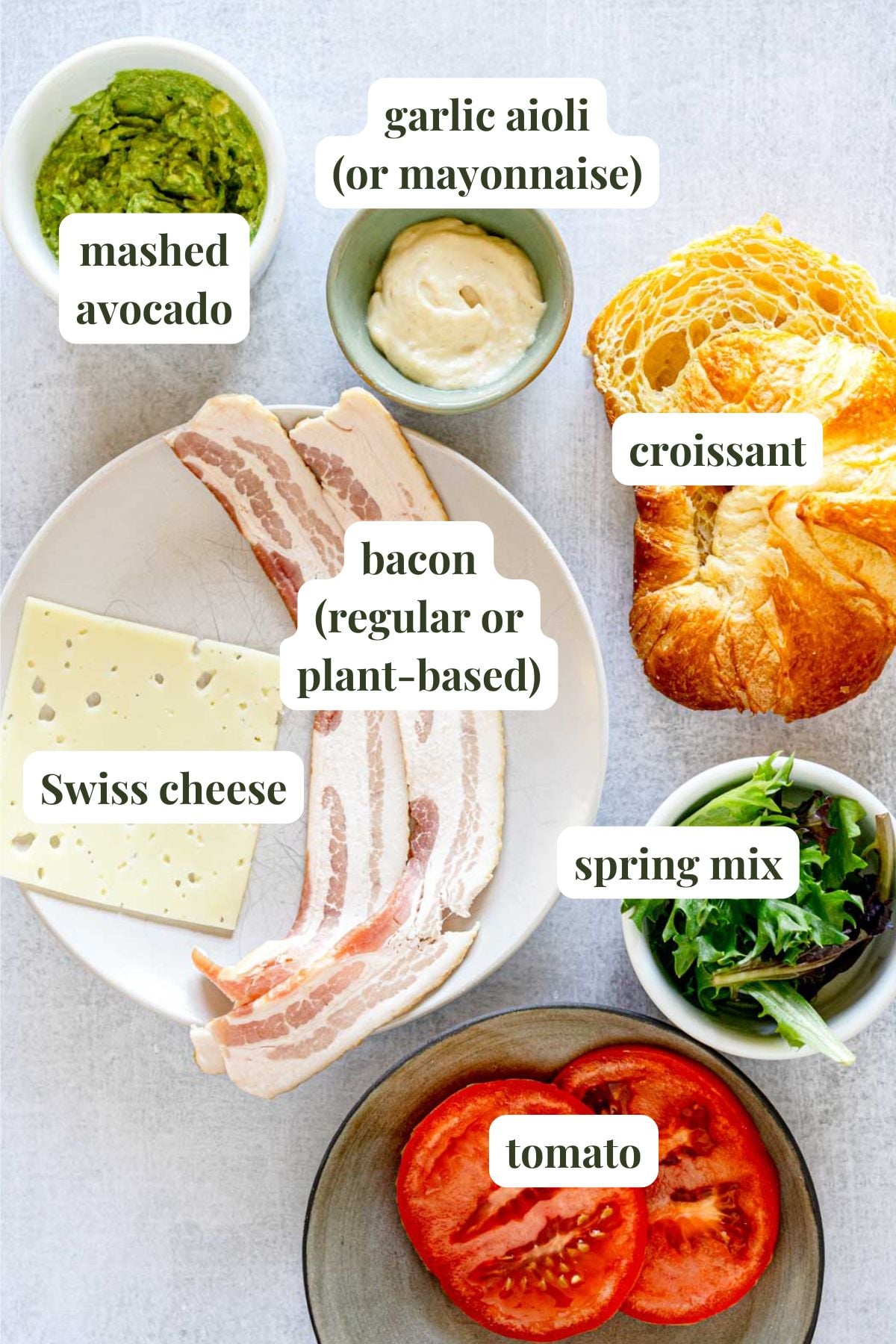 Labeled ingredients to make a bacon avocado croissant sandwich.