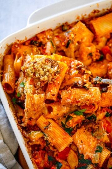 Closeup of baked rigatoni pasta with vegetables.