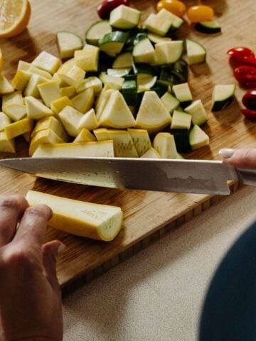 Cutting yellow squash, zucchini, tomatoes, and lemon.