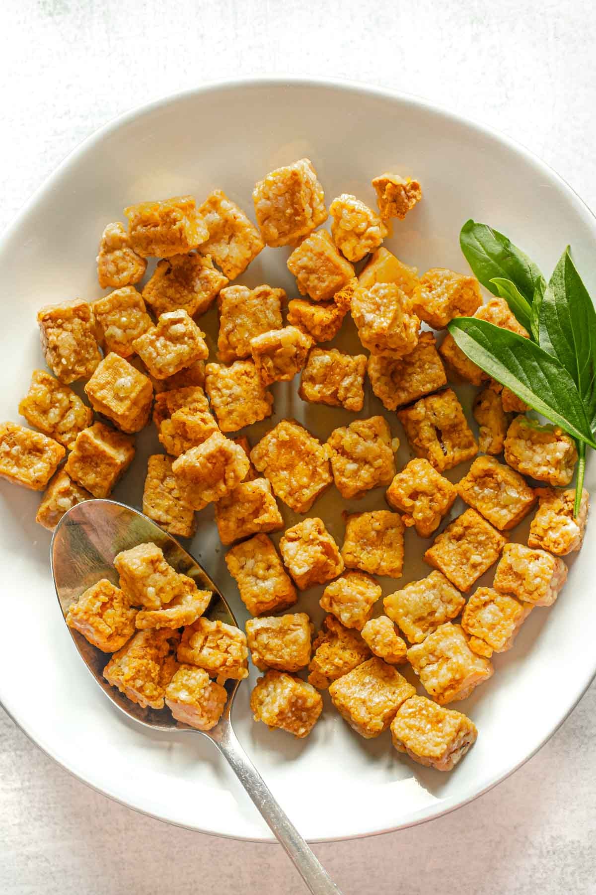 Crispy air fryer tofu on a white plate.