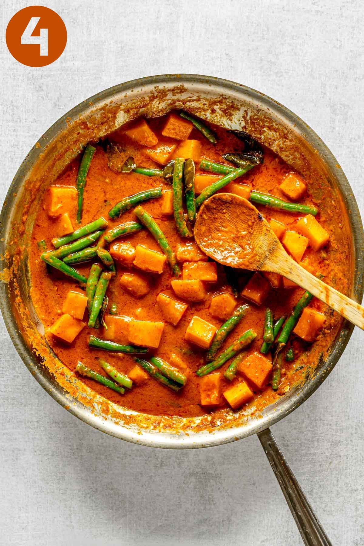 Thai red curry cooking with vegetables in a skillet; labeled 4.