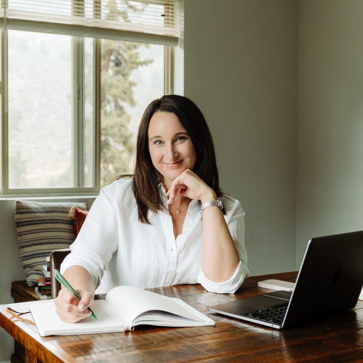 Stephanie McKercher, dietitian, sitting at her desk with a notebook and laptop.