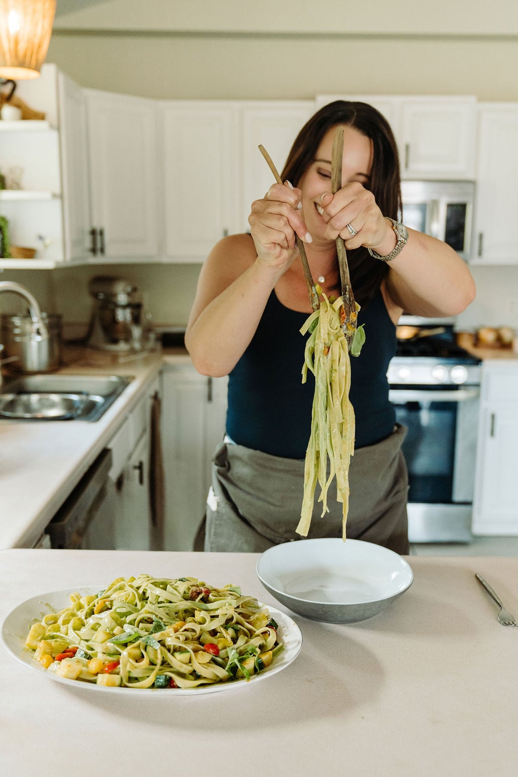 Serving pasta with green sauce.