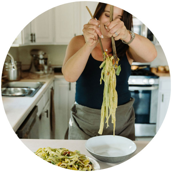 Stephanie McKercher serving pasta in her kitchen.