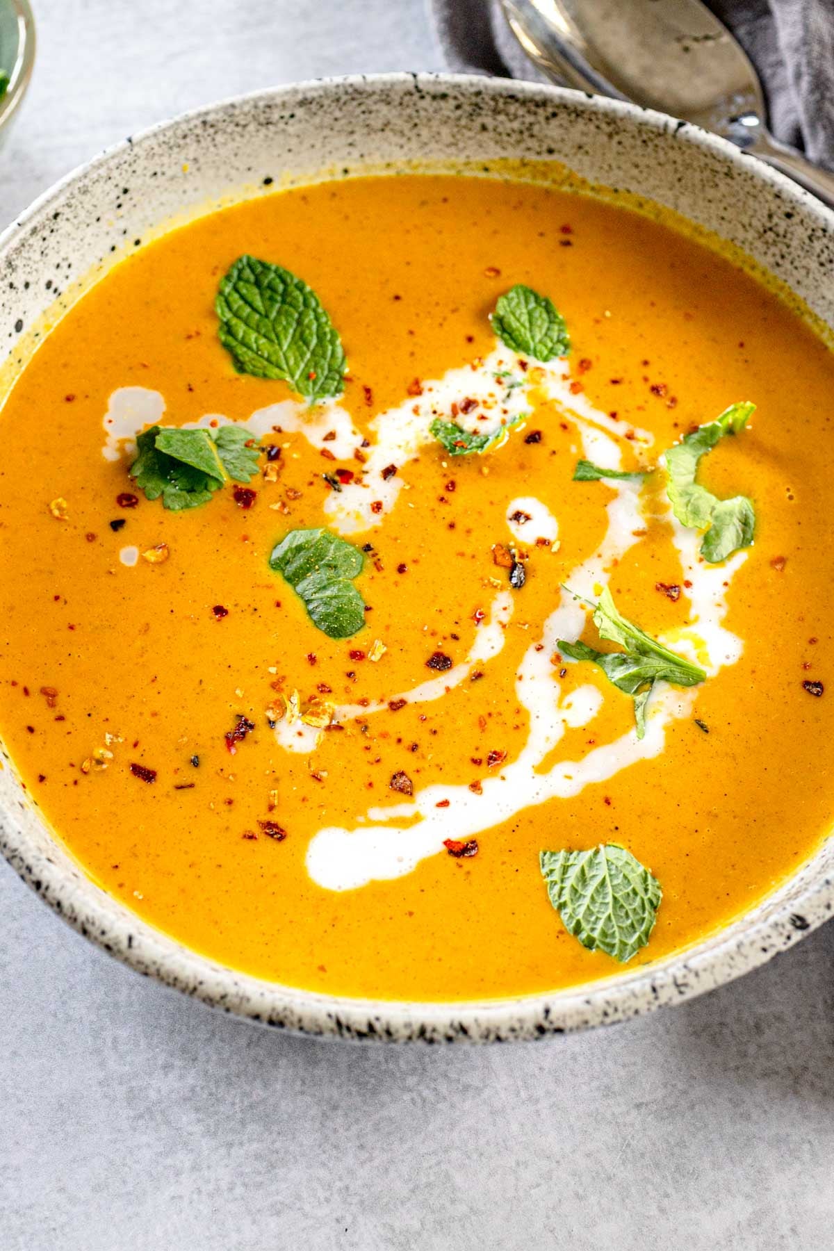 Closeup of curried pumpkin soup with garnishes.