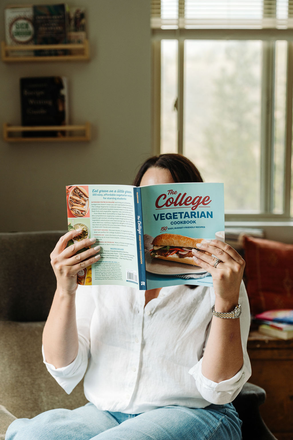 Stephanie McKercher reading her cookbook, The College Vegetarian Cookbook.
