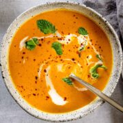 A bowl of pumpkin soup with curry powder and coconut milk.